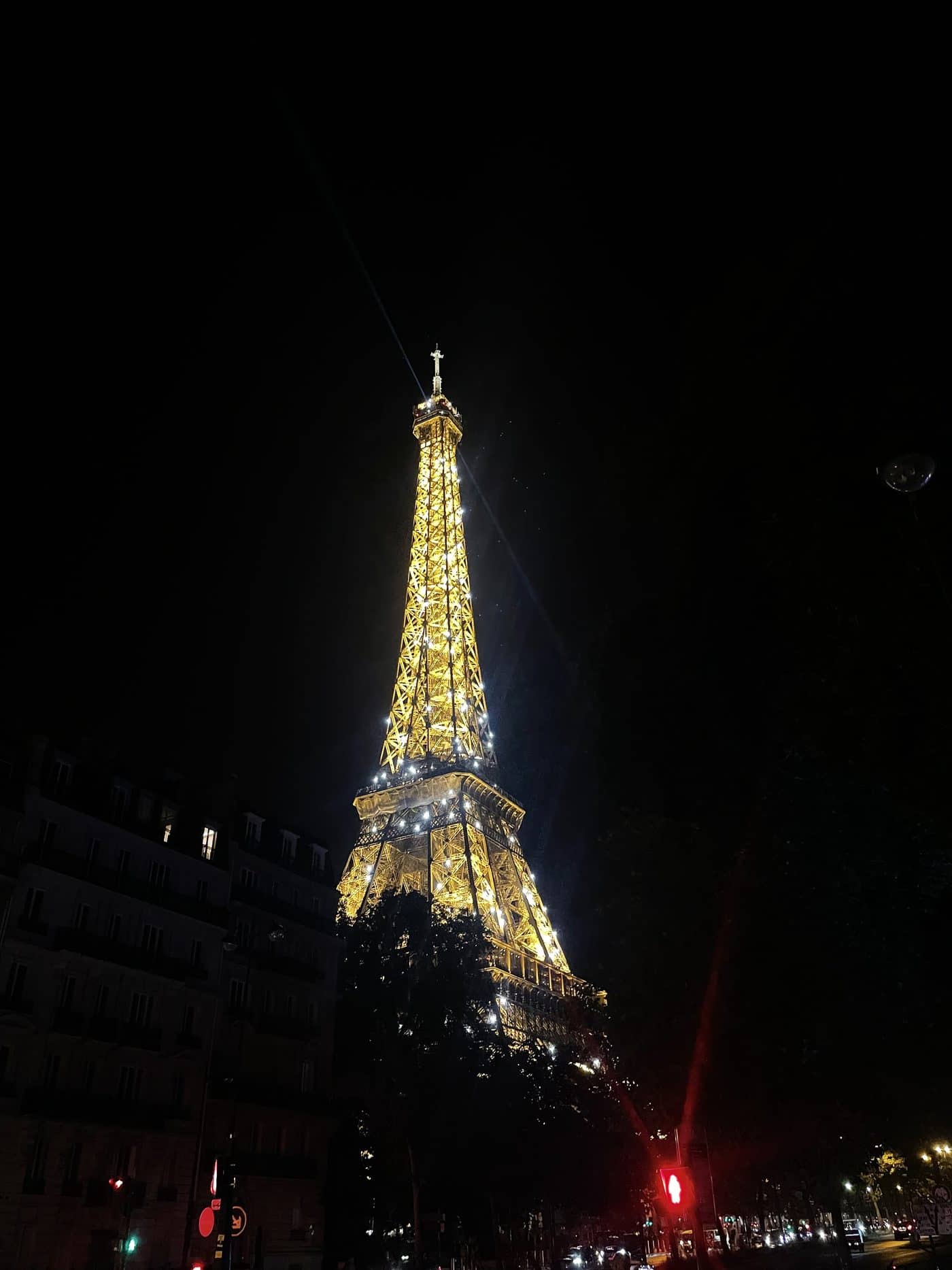 The Eiffel Tower lit gold at night