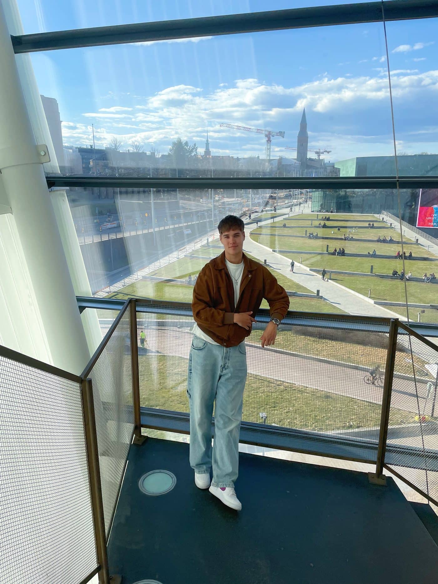 Lucas on a balcony at Oodi library in Helsinki