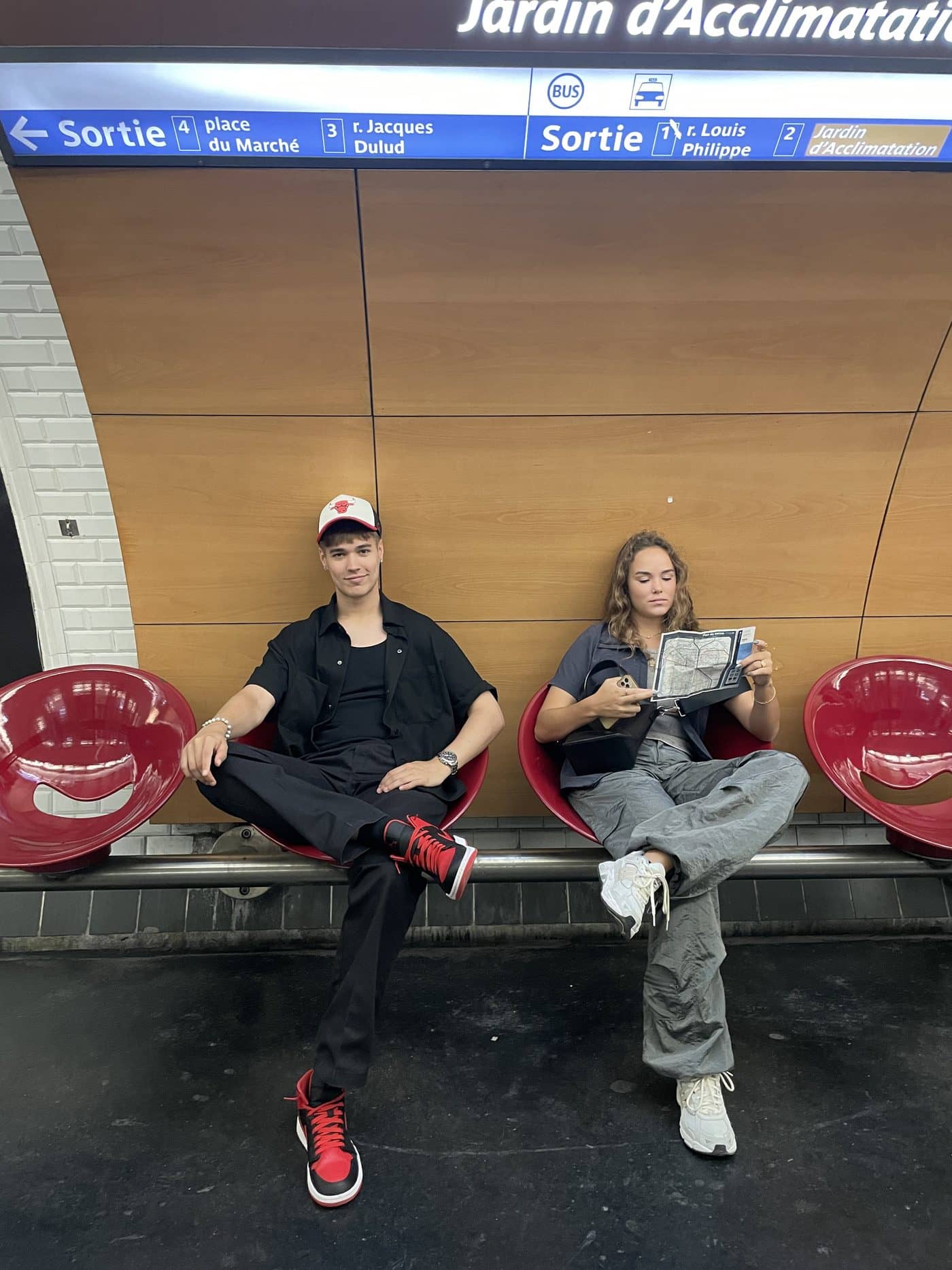 Lucas and a friend on red seats in the Paris metro