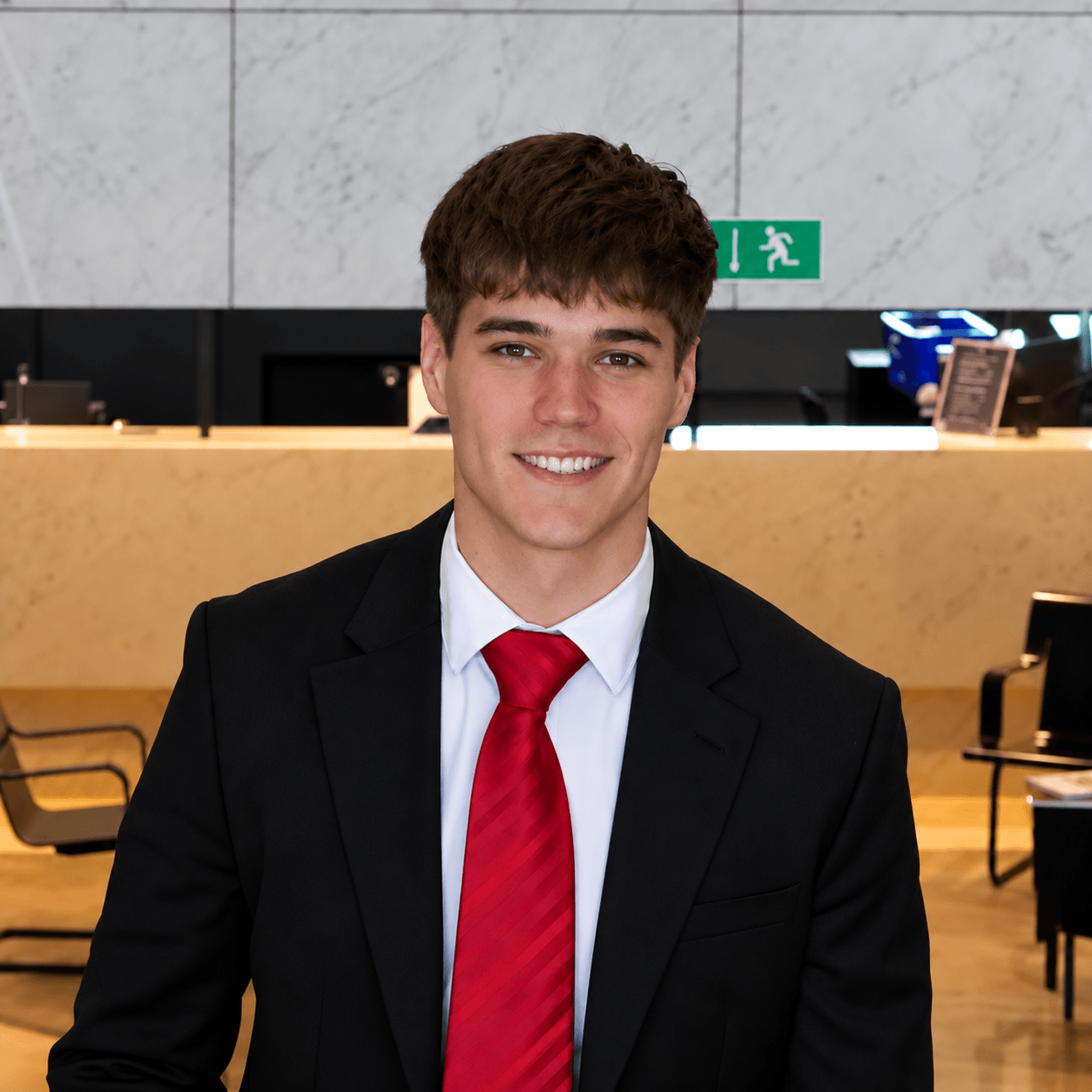 Portrait of Lucas Pastel wearing a red tie